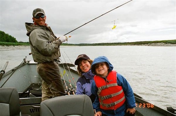 family fishing on boat in kenai river