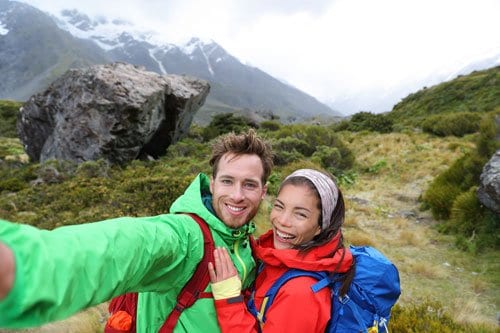 couple taking selfie on top of mountain