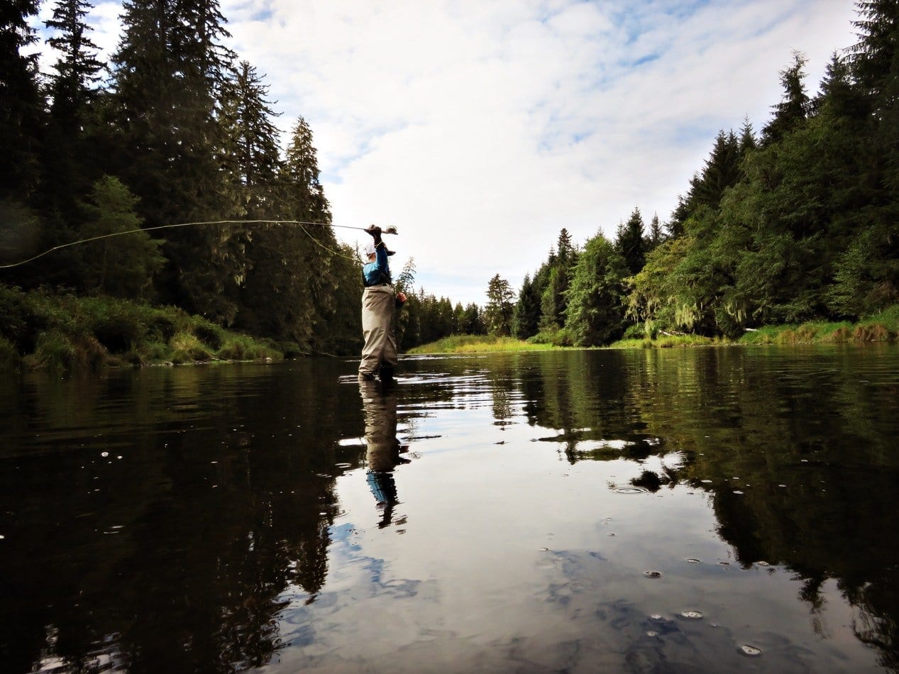 man fly fishing in Alaska river