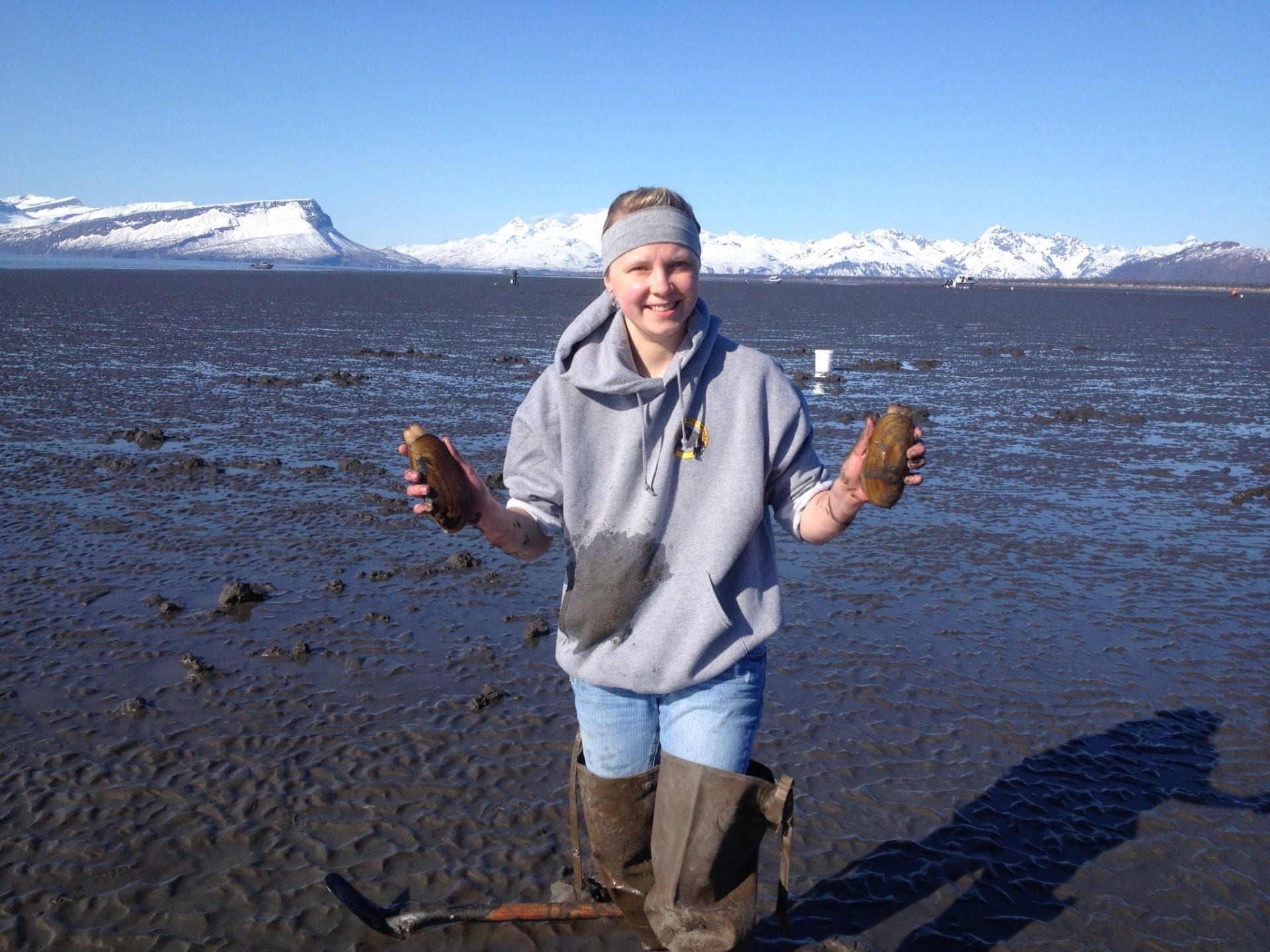 woman holding 2 clams