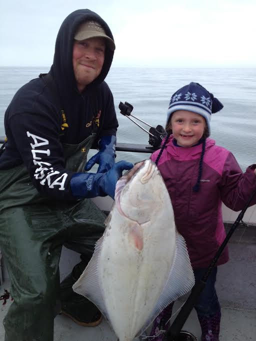 father and daughter with large fish catch