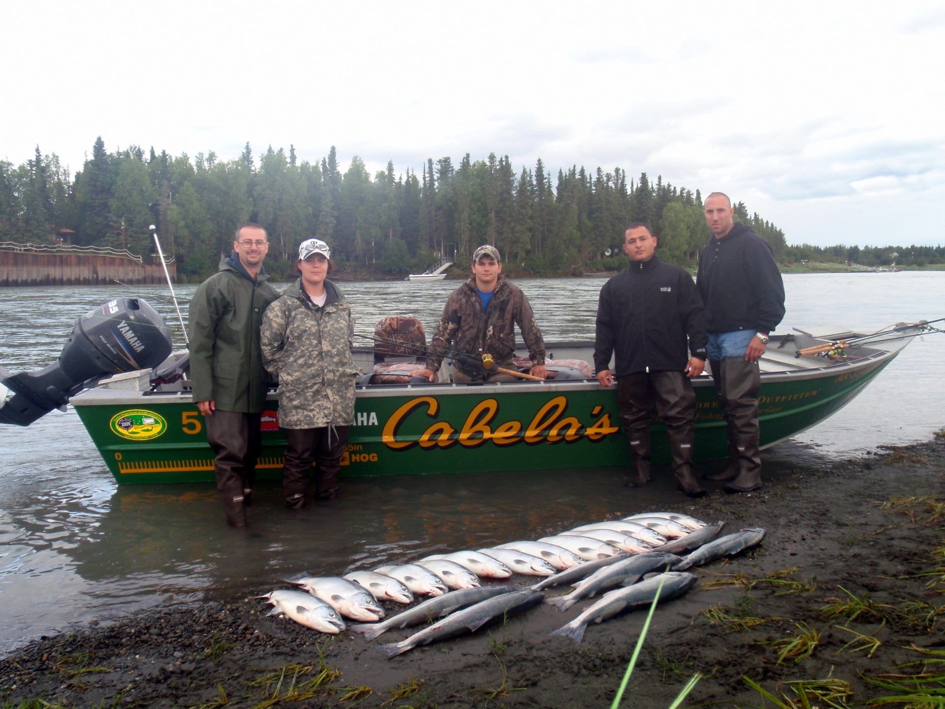 small group of fishers with their catches