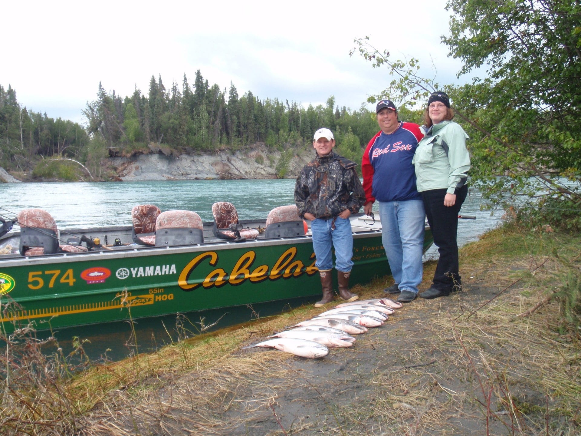 3 fishers standing in front of their catch