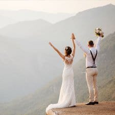 bride and groom overlooking Alaska mountains