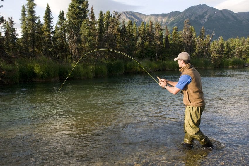 man fly fishing in alaska