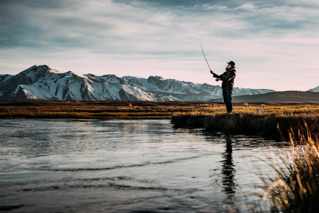 man in hat fishing in Alaska