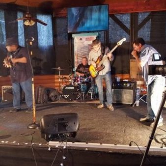 57561082_2450804898320485_5678119762299715584_n band playing on stage