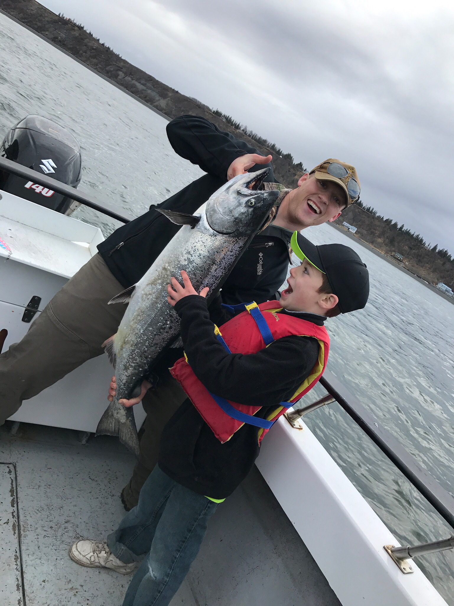 amazed boy marveling at huge salmon