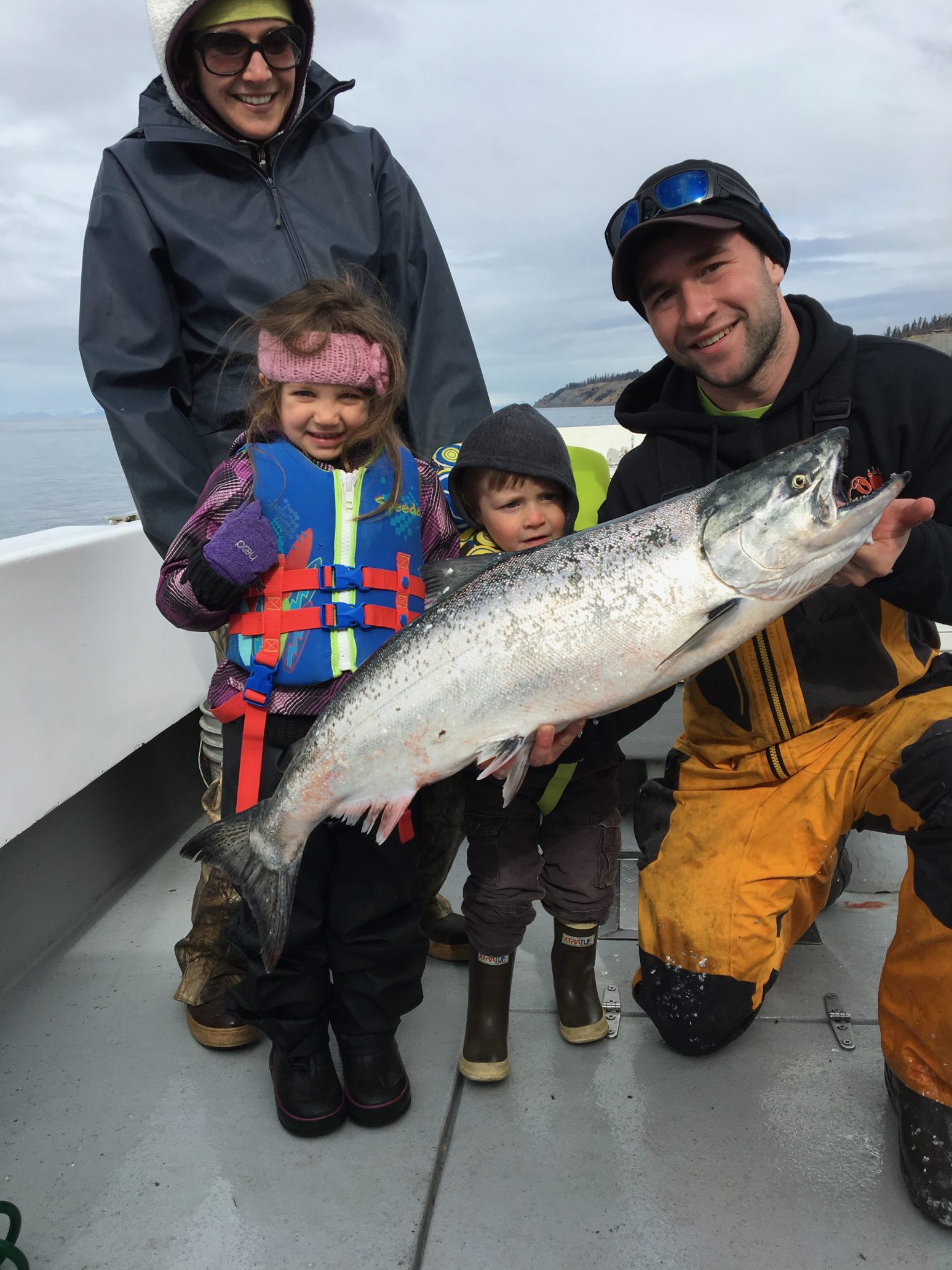 family with large Alaska salmon