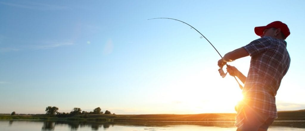 person fishing in Alaska lake at sunrise