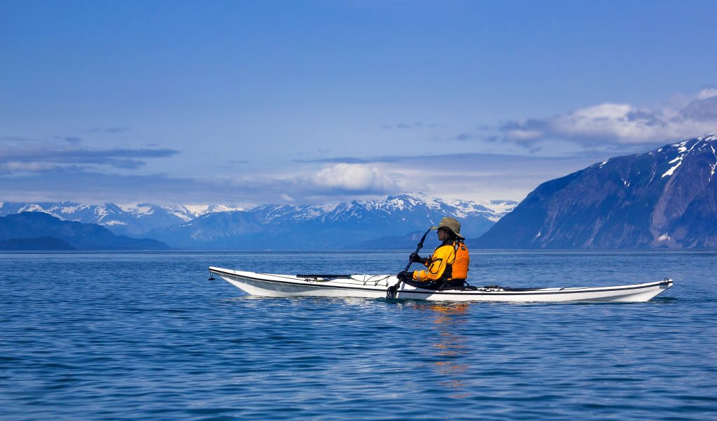 Female kayaker paddling in Glacier Bay National Park Alaska