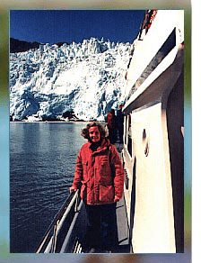 woman in red jacket on a boat at Alaska glacier