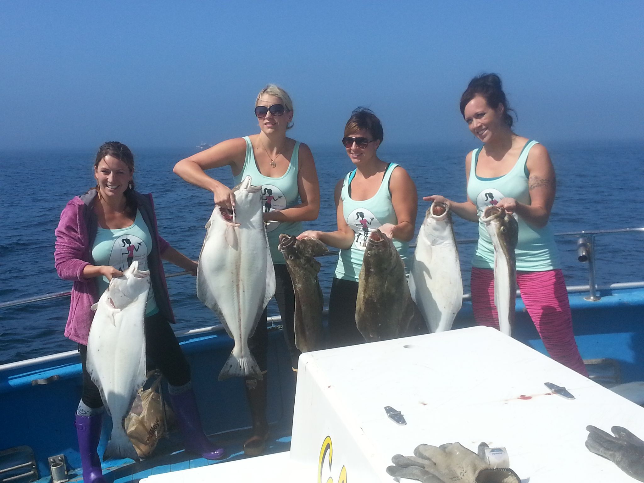 4 women holding halibut